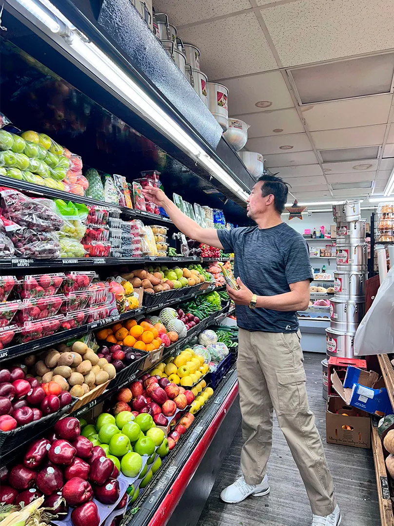 Man buying fresh fruits at La Placita Meat Market