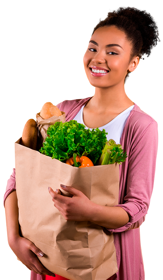 Smiling woman carrying a shopping bag full of vegetables